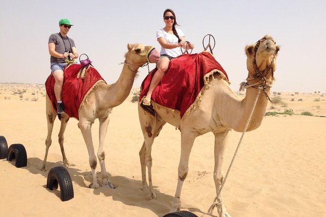 Desert Safari with BBQ Dinner and Landcruiser Pickup - Camel riding, henna, and Arabic dress at the camp