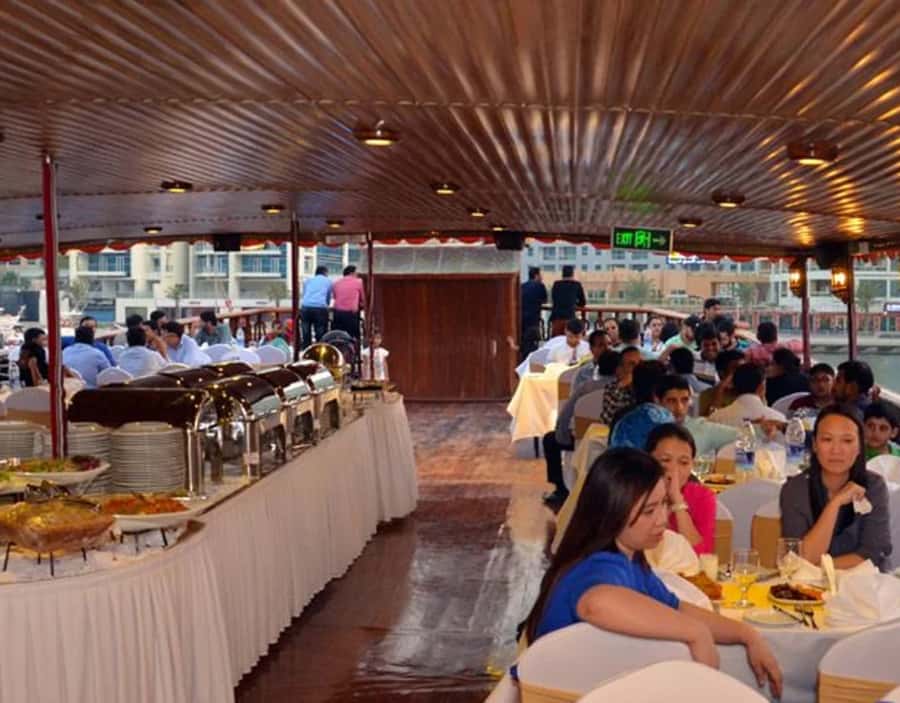 Dubai: Dhow Dinner Cruise on Creek or Marina with Live Shows - Boarding a traditional wooden dhow