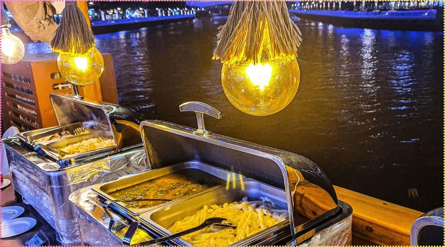Dubai: Marina Dhow Dinner Cruise with Live Entertainment - A slower view of Dubai Marina after dark