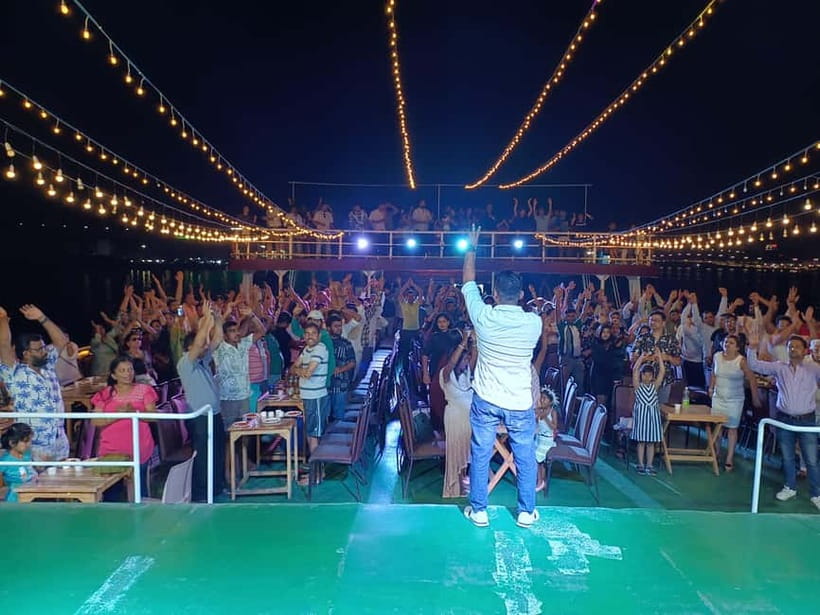 Panaji: Dinner Cruise with Drinks and Live Entertainment - Panaji by night, with lights reflected on the river