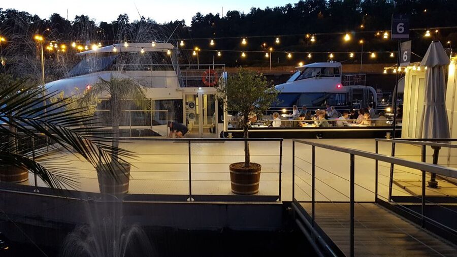 Prague: City Tour and Dinner Cruise with Hotel Pickup - Boarding the boat for a three-hour Vltava cruise
