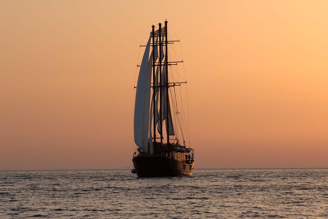 Santorini Caldera Sunset Sailing Cruise with Dinner and Wine - Thirassia Bay: Greek dinner with the caldera as your dining room