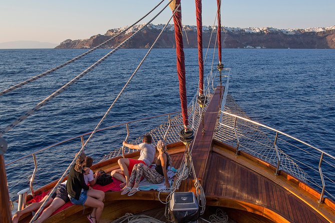 Santorini Caldera Sunset Sailing Cruise with Dinner and Wine - Sunset near Oia, seen from the water
