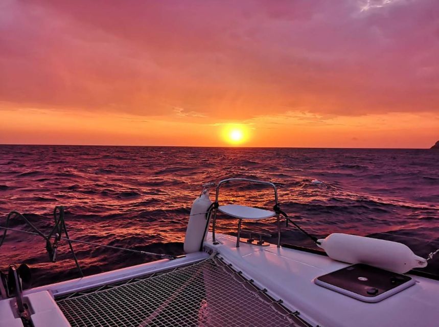 Santorini: Sunset Cruise with Greek Dinner and Transfer - Red Beach and White Beach from the sea