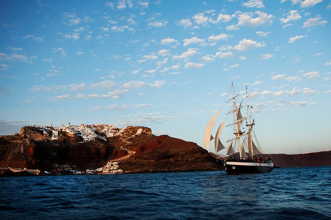 Santorini Sunset Dinner Cruise Including Nea Kameni Visit - Leaving the port with Santorini above you