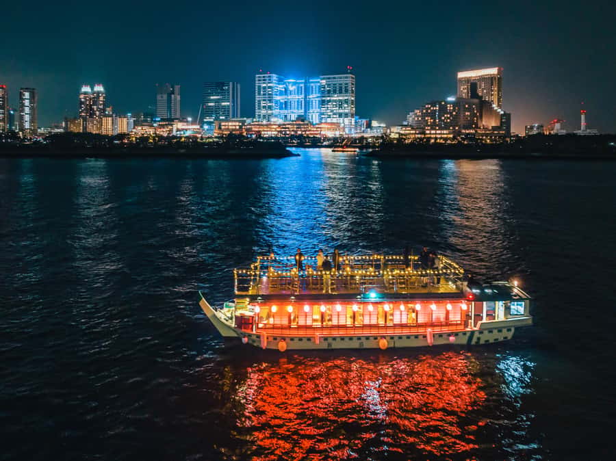 Tokyo: Yakatabune Dinner Cruise with Japanese Show & Drinks - A traditional boat with Tokyo outside the windows