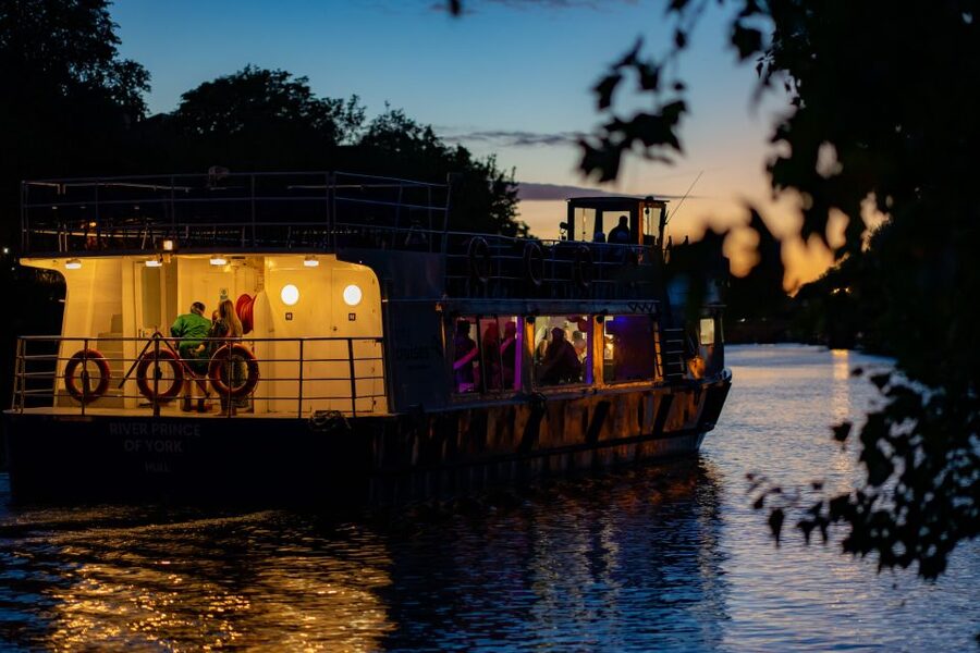 York: Party Cruise with Drink, Dinner, and DJ - York after dark from the river